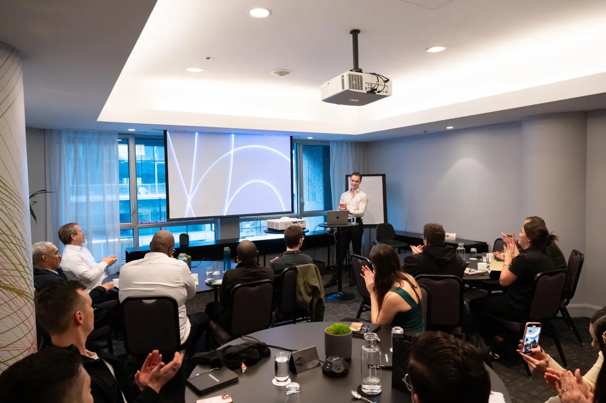 The team applauding during a presentation